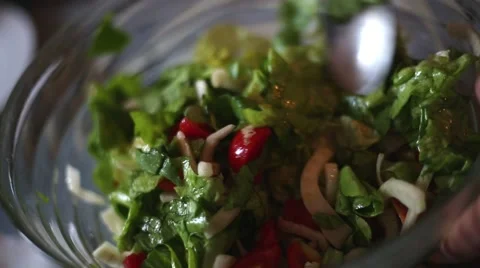 Hands mixing the salad on the table for lunch Stock-Footage 55629629