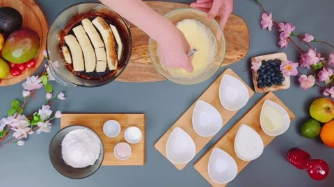 Hands mixing yellow batter for baking on kitchen table Stockbeeldmateriaal 342937196