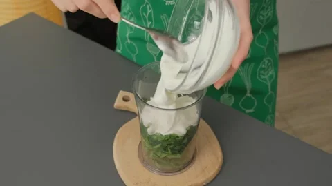 Hands Mixing Yogurt into Jar with Spinach Cooking Kitchen Stock Footage 341418209
