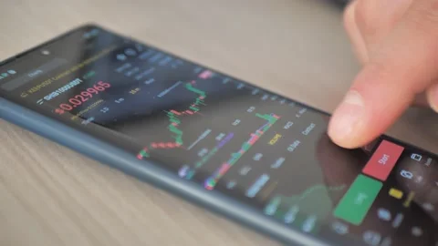 Hands with a mobile phone, checking stock market data. Scrolling through Stock Footage 176970071