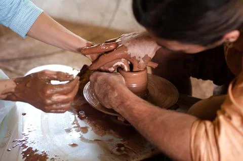 Hands mold a pot from clay. Master class of pottery close-up Stock Photos