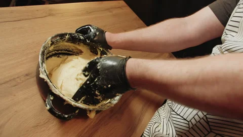 Hands molding moist dough within enameled vessel in kitchen Vídeos de archivo 330536658