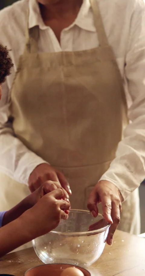 Hands, mom and child with egg for baking, cake mixture and teaching family Stock Footage 343310793