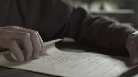 Hands of a monastic scribe rolling out a manuscript sheet on a table Stock Footage 340079888