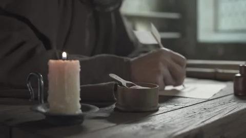 Hands of a monk writing calligraphy text on parchment, camera tracking Stock Footage 337649158
