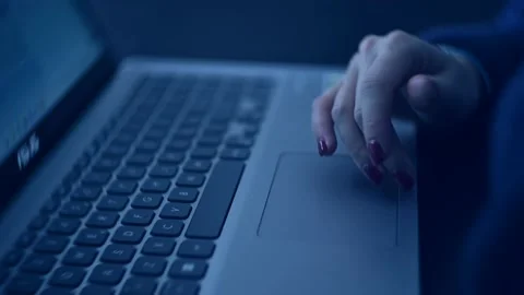 Hands in Motion: A Woman at the Computer Under Blue Light Stock Footage 232797778