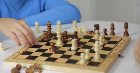Hands move pieces on chess board during match. Child and adult play chess game Stock Footage 328710370