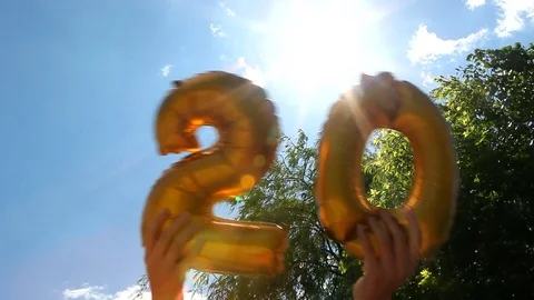Hands moves air balloons as 20 years anniversary concept 스톡 동영상 76234480