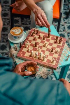 Hands moving chess pieces during a cafe game 스톡 사진