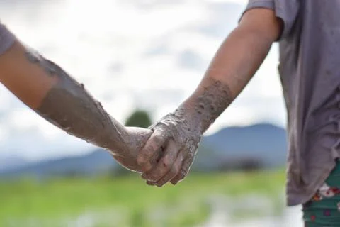 Hands mud clay of two child holding each other. Stock Photos