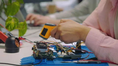 Hands of the Multiracial Guy Engineer Measuring the Temperature of the Circuit Stock Footage 252281263