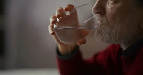 Hands Near a Wine Glass on a Patterned Table in Soft Indoor Light Vídeo Stock 336285254