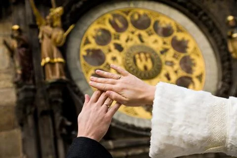 Hands of newly married on clock background Stock Photos
