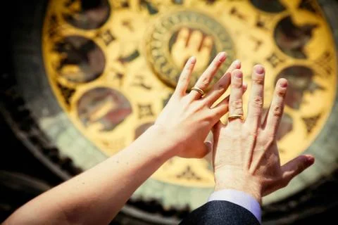 Hands of newly married on clock background Stock Photos