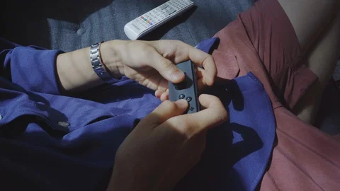 Hands on Nintendo switch controller- playing video games Stock Footage 127783018