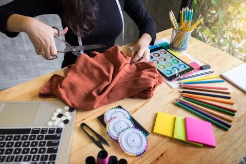 Hands notch tailor tailor's scissors cloth cutting a piece of fabric (fashion Stock Photos