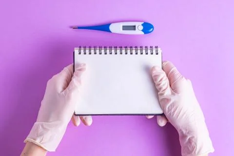 Hands with a notebook in rubber gloves with a thermometer Stock Photos