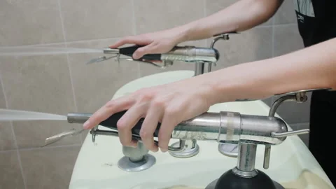 Hands of nurse regulate Charcot douche equipment in clinic Video stock 194630119