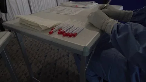 Hands of nurses writing down patients' personal data after the covid-19 test Stock Footage 142870716