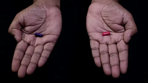Hands Offer Red or Blue Pill Choice Stock Footage 248779858
