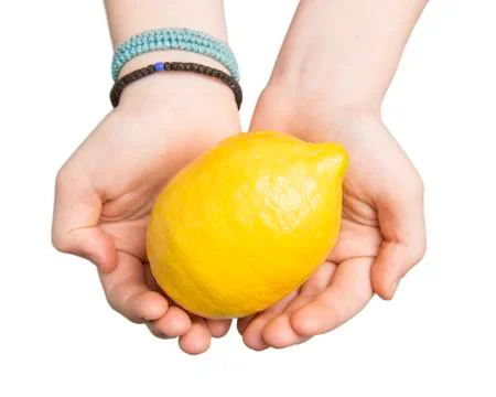 Hands Offering a Lemon Stock Photos