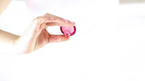Hands Offering red condom 스톡 동영상 34866194
