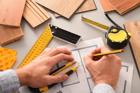 Hands in office developing interior project with wood elevated view Stock Photos