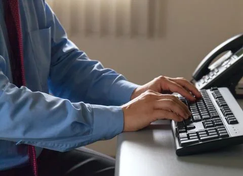 Hands of office worker typing on the keyboard Stock Photos