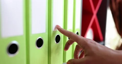 Hands of official remove folder with secret documents from shelf Stock Footage 220084748