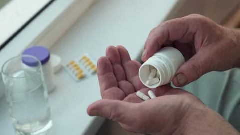 Hands Of Old Ill Man Takes Out Pull From Bottle On Palm Stock Footage 300359272