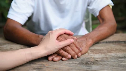 Hands of the old man and a man hand on the wood table. encouragement, Stock Footage 202063991