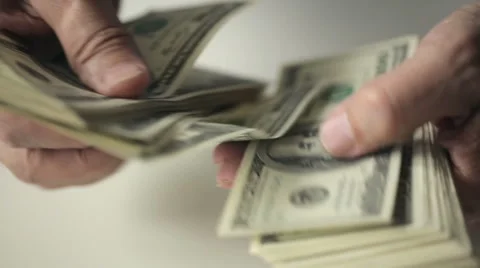 Hands of an old man counting hundred dollar bills at a table. Slow motion Stock Footage 47139599