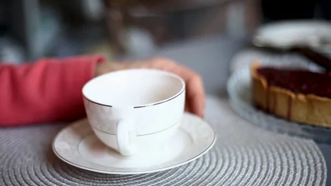 Hands of an old man near a light cup Stock Footage 201332519