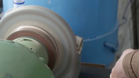 Hands old master grind detail on bench grinder, rough grinding machine, close Stock Footage 105839923