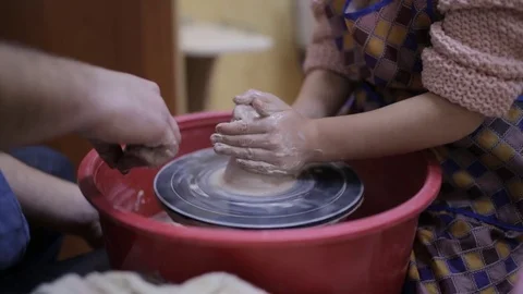 Hands of old potter and young pupil Stock Footage 70173675