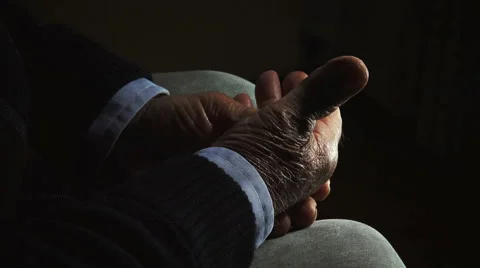 Hands of old retired man: elderly man sitting alone in the darkness Video stock 56151341