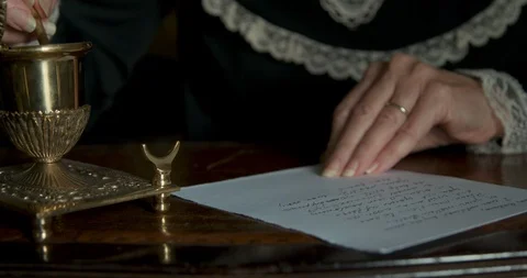 Hands of old woman writing a letter with fancy dip pen Stock Footage