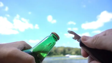 Hands open bottle opener with beer bottle in slow motion Stock Footage 134833075