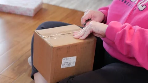 Hands Open Box with Pink Sweatshirt Stock-Footage 145737346