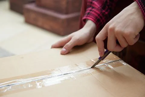 Hands open a box of thing. Delivery service. Stock Photos