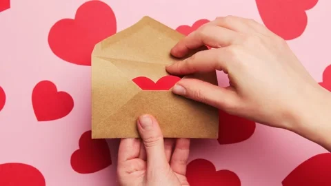 Hands open craft envelope letter with a valentine red heart Stock Footage 145717852