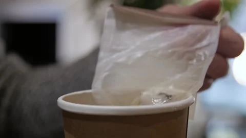 Hands open a cup of tea and pick up a bag of tea. Close-up shot Stock Footage 169822494