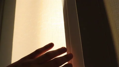 Hands open the curtain on the window. Beautiful sunbeams in the window. Slow Stock Footage 91618117