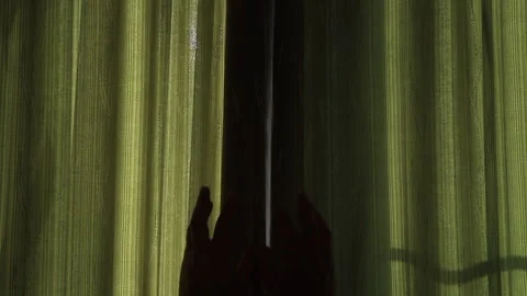 Hands open the curtains in a dark room and the bright light of the sun appears Stock Footage 130940694