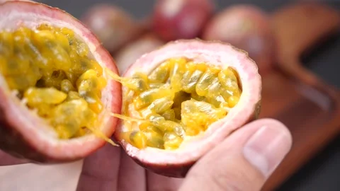 Hands open half passion fruit in slow motion. Passion Fruit for healthy eating Stock-Footage 142774827