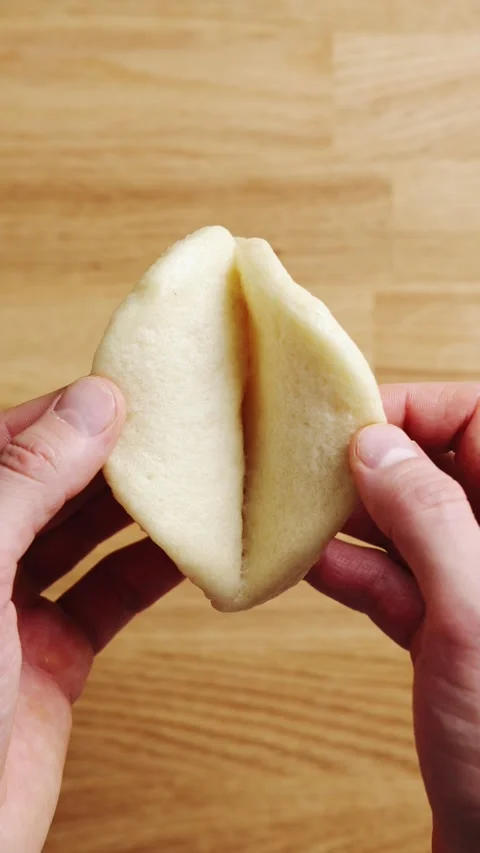 Hands open hot bao bun just after steaming. Stock Footage 341951437