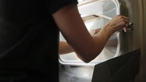 Hands Open Mash Tun to Reveal Spent Grain Stock Footage 203517552