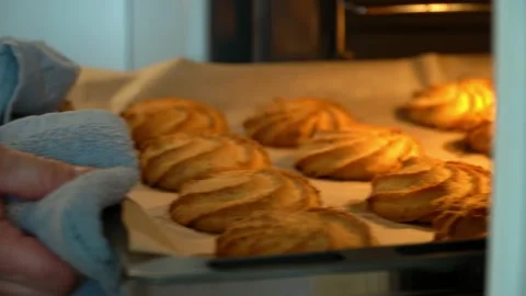 Hands open oven door and take out baking sheet with baked cookies. Bakery Stock Footage