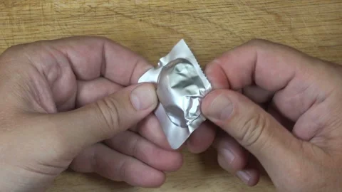 Hands open the pill from the package. Stock Footage 154858094