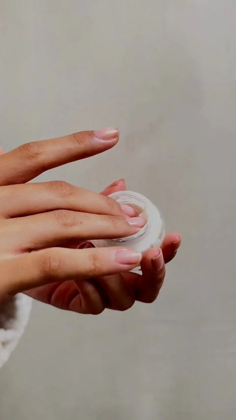 Hands open small glass jar and take white cream Stock Footage 331773379